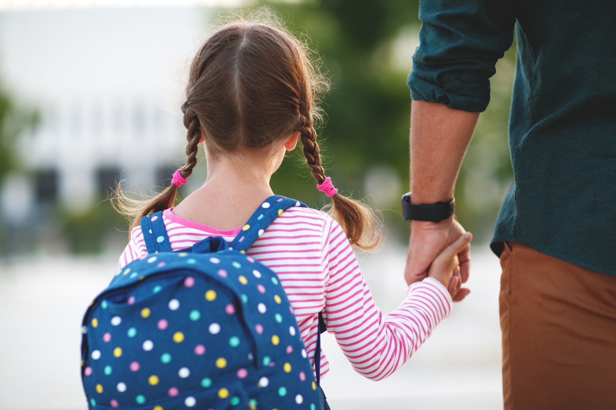 Father walking little girl to school
