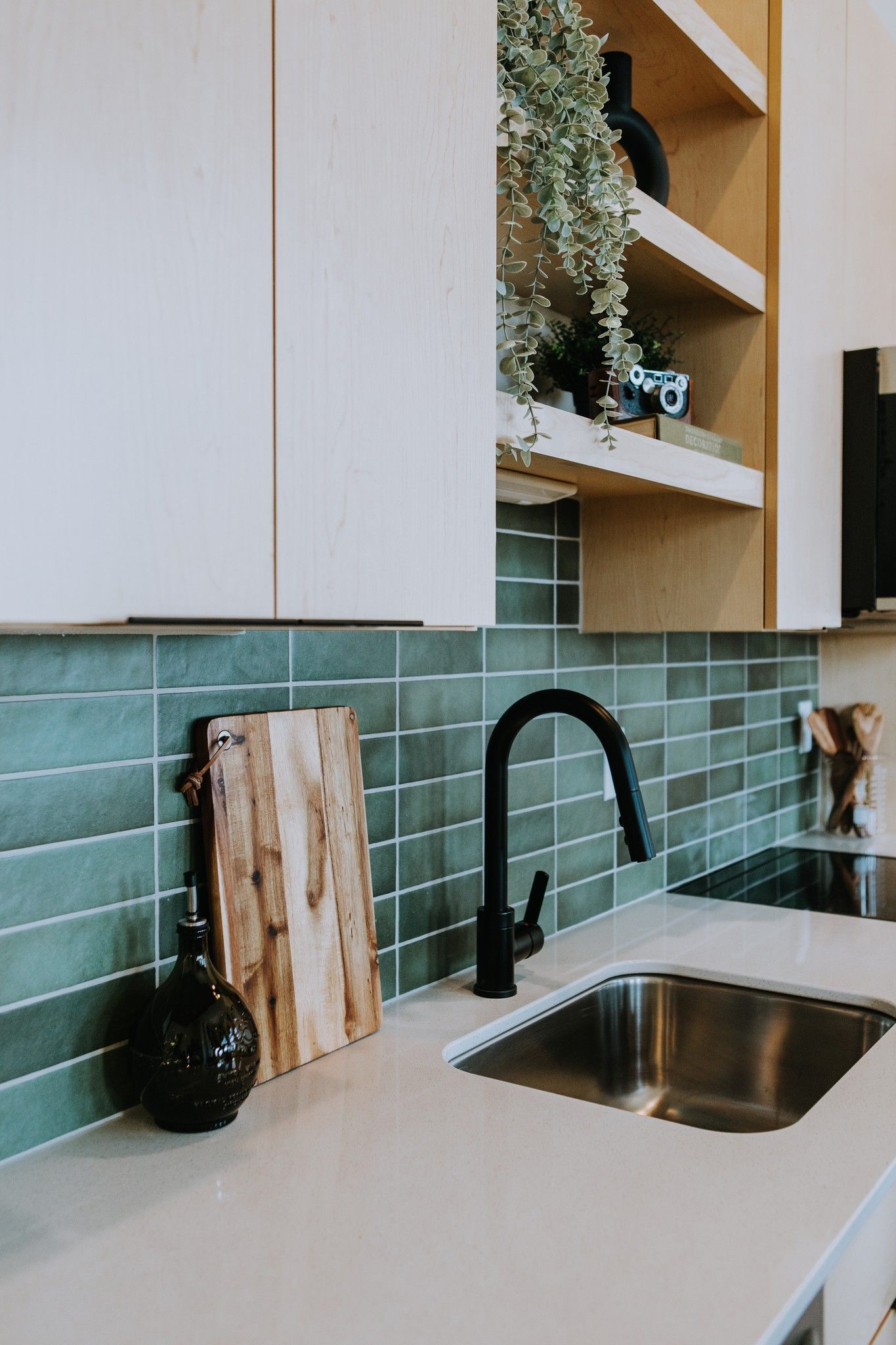Modern kitchen with green tile backsplash